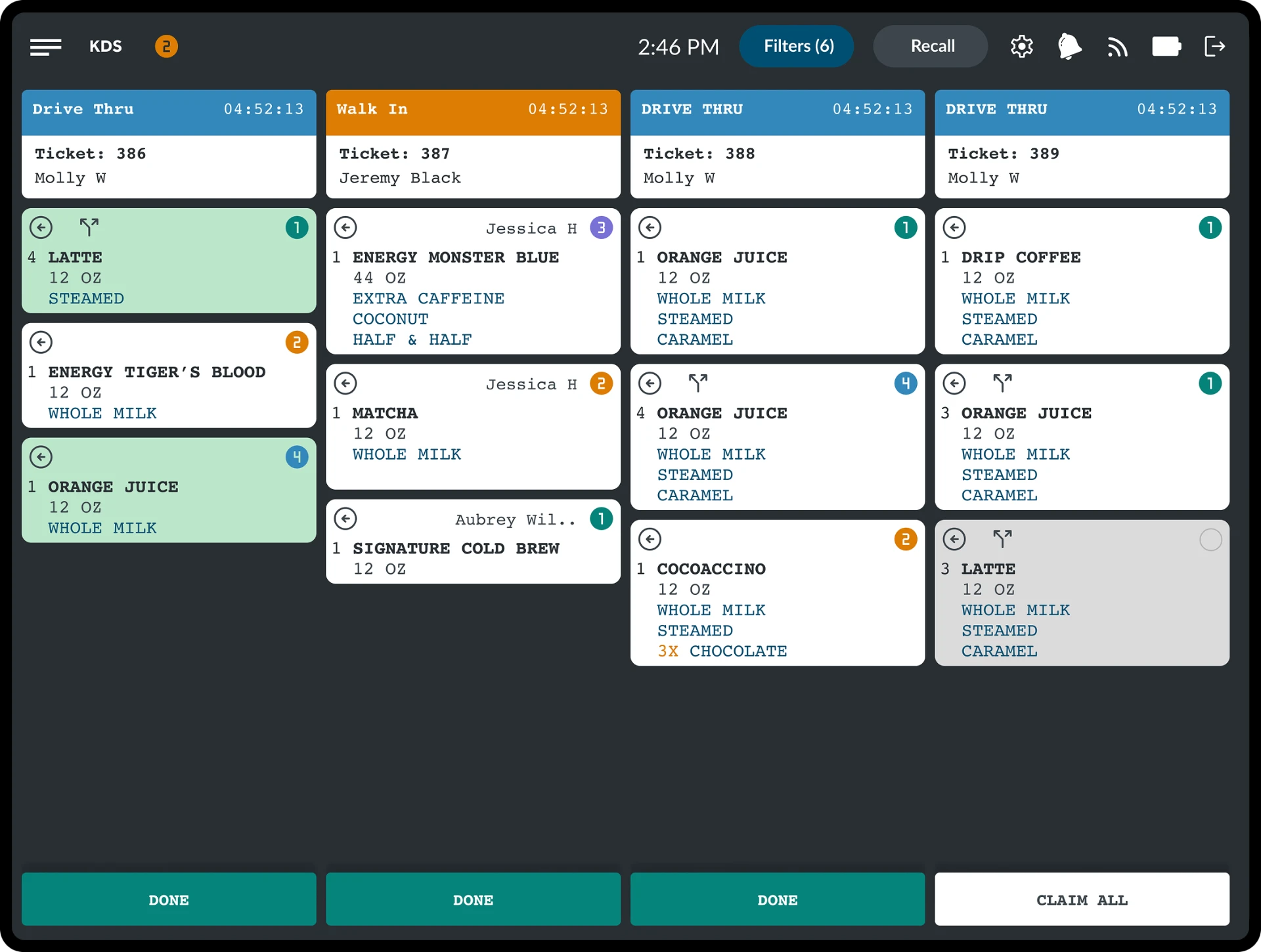 Kitchen display showing drive-thru and walk-in tickets with drink builds, modifiers, and done actions
